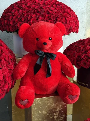 Close-up of luxury plush teddy bear paw with embroidered heart detail